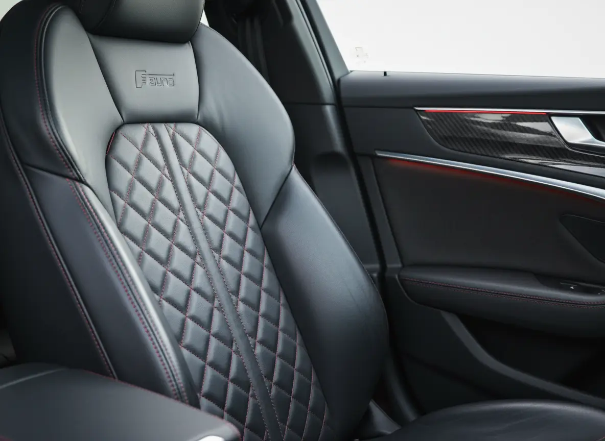 Quilted black leather seat with red contrast stitching